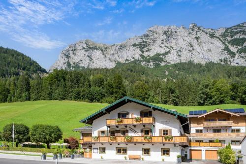 a building with a mountain in the background at Wörndlhof - Das Refugium in Ramsau