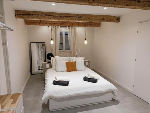 une chambre avec un grand lit blanc avec deux serviettes dessus dans l'établissement Belle maison mitoyenne de standing, à Fréjus