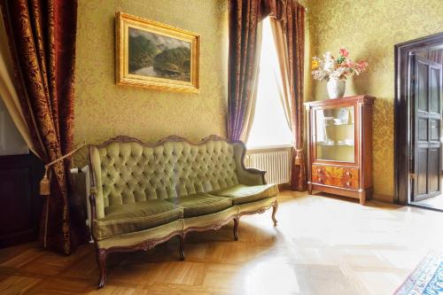 a living room with a couch and a window at Burbiskio dvaras in Anykščiai