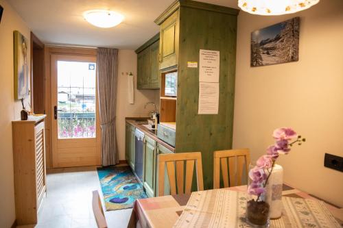 a kitchen with a table and a dining room at Bait da Menego in Livigno