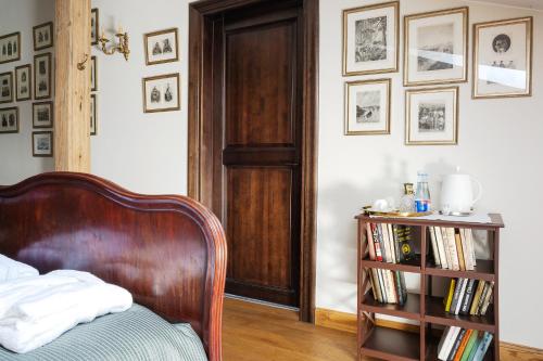 a bedroom with a bed and a book shelf with books at Burbiskio dvaras in Anykščiai