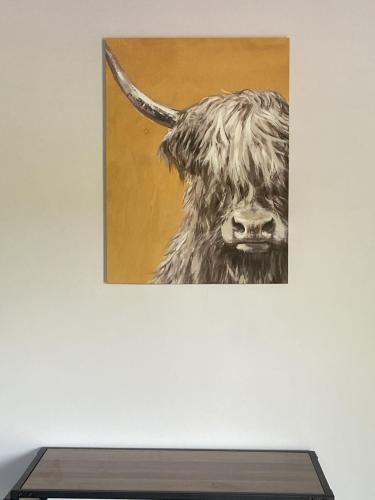 a painting of a cow hanging on a wall at The Lydden Bell in Dover