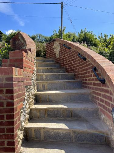 a set of concrete stairs with a brick wall at The Lydden Bell in Dover