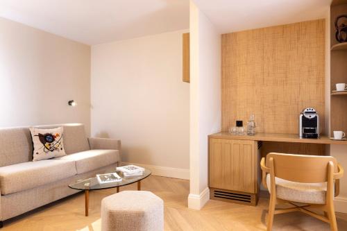 a living room with a couch and a table at Padam Hôtel in Paris