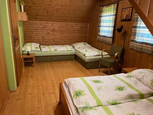 a room with three beds in a cabin at Drevenica Čakanka a Nezábudka in Terchová
