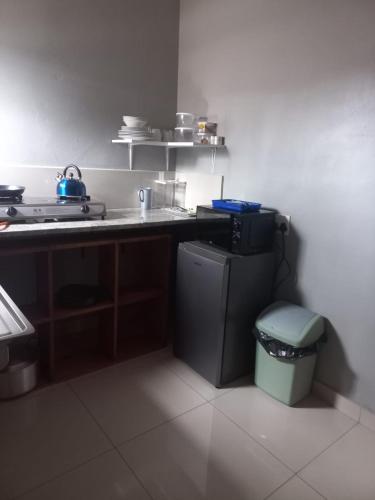 a kitchen with a sink and a trash can at Rocky Hills Guesthouse in Piet Retief