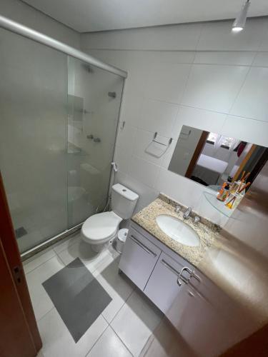 a bathroom with a toilet and a sink and a shower at Vista Panorâmica com piscina in Porto Alegre