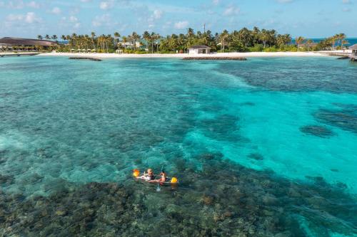 a group of people in a boat in the ocean at Kagi Maldives Resort & Spa in North Male Atoll