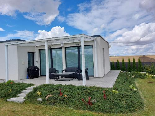 a white house with glass doors and a patio at Apartmán Polička in Polička