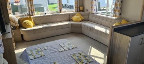 a living room with a couch and a rug at Ashdale By Sea in Whitstable