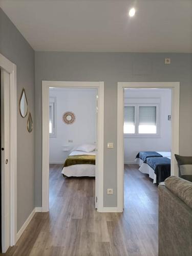 a living room with two beds and a couch at Pensión Os Mollados in O Pedrouzo