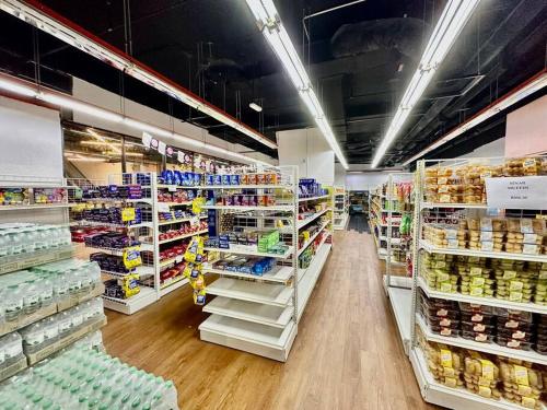 a grocery store aisle with a lot of products at Kuching Kozi Square Apartment III in Kuching