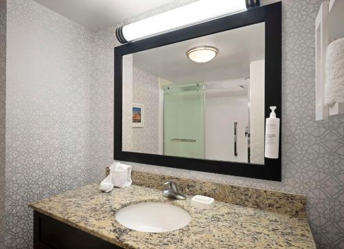 a bathroom with a sink and a mirror at Hampton Inn & Suites Arundel Mills/Baltimore in Hanover