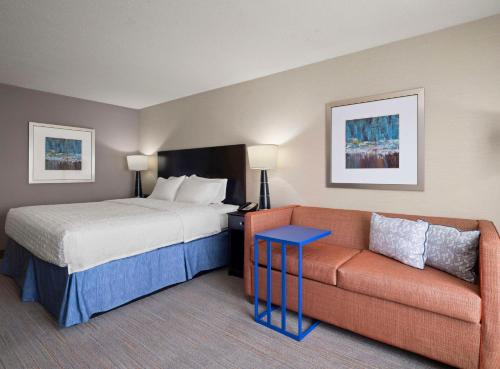 a hotel room with a bed and a couch at Hampton Inn & Suites Arundel Mills/Baltimore in Hanover