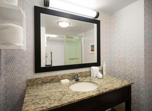 a bathroom with a sink and a large mirror at Hampton Inn & Suites Arundel Mills/Baltimore in Hanover