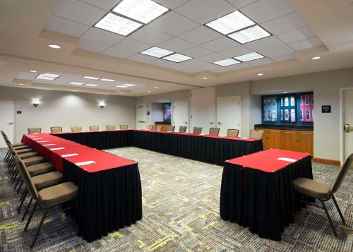 a conference room with red tables and chairs at Hampton Inn & Suites Arundel Mills/Baltimore in Hanover