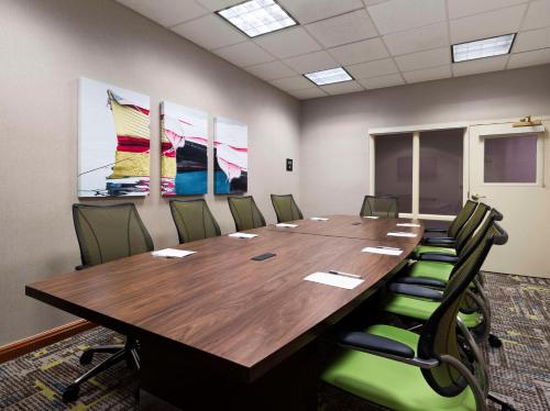 a conference room with a large wooden table and chairs at Hampton Inn & Suites Arundel Mills/Baltimore in Hanover