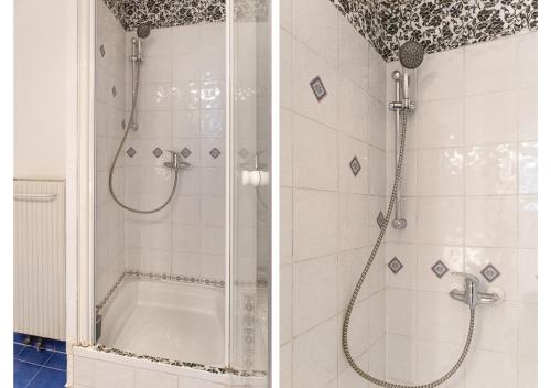 y baño con ducha con puerta de cristal y bañera. en Deluxe 3BR Apt. Wiener Stadthalle - Suitable for Longstays, en Viena