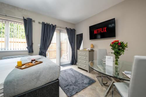 a bedroom with a bed and a glass table at Blossomfield Serviced Apartment, Solihull, Near NEC and Airport in Solihull