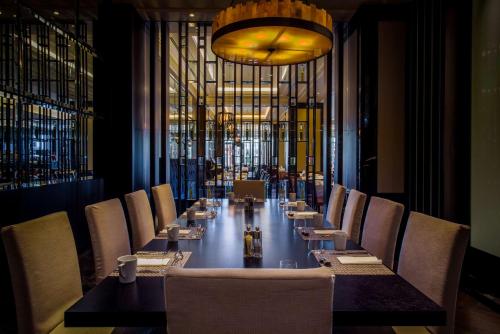 a long dining room with a long table and chairs at Hilton Istanbul Bomonti in Istanbul