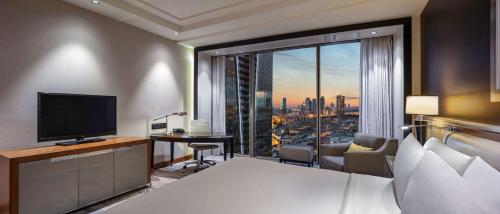 a hotel room with a bed and a large window at Hilton Istanbul Bomonti in Istanbul