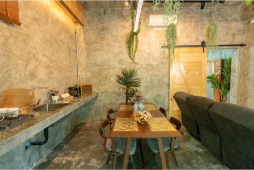 a kitchen with a table and a sink in a room at Grandfather Khaolak Resort in Khao Lak