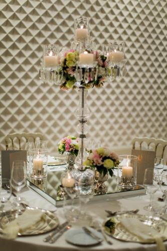 a table with a chandelier with candles and flowers at Hilton Istanbul Bomonti in Istanbul