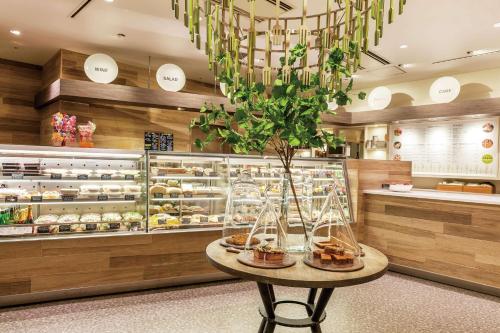 a bakery with a table with a vase on it at Hilton Tokyo Bay in Urayasu