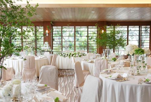 a room full of tables with white tablecloths at Hilton Tokyo Bay in Urayasu