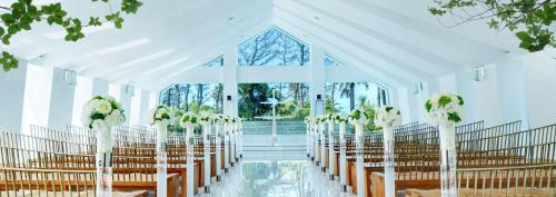 a white chapel with rows of chairs and a window at Hilton Tokyo Bay in Urayasu