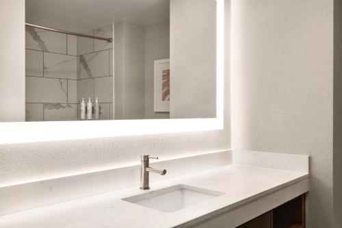 a bathroom with a sink and a mirror at Hampton Inn Virginia Beach-Oceanfront South in Virginia Beach