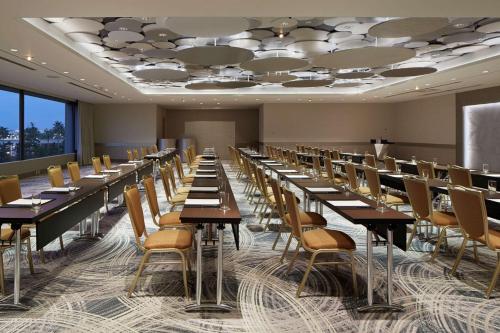 a row of tables and chairs in a room at Hilton Tokyo Bay in Urayasu