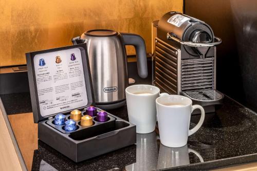 a counter with two cups of coffee and a coffeemaker at Hilton Tokyo Bay in Urayasu
