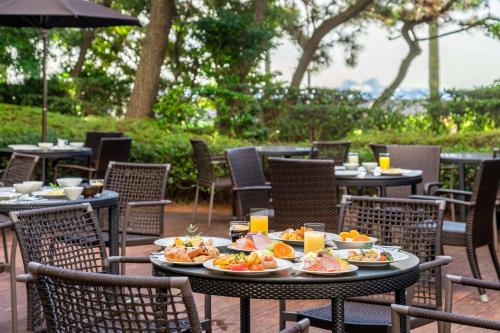 a table with plates of food on top at Hilton Tokyo Bay in Urayasu