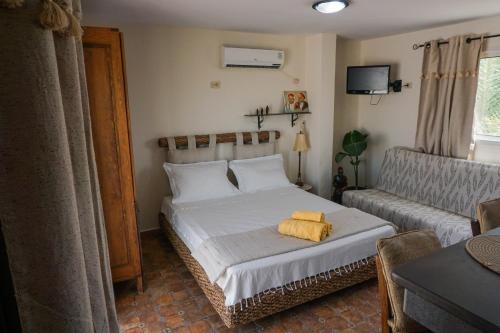 a bedroom with a bed and a couch at Cozy Studio with Rooftop Terrace & Cityscape Views in Le Bardo