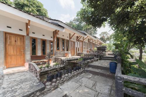a row of buildings with stairs leading to them at Urbanview Hotel D'Pineapple Villa Ciater by RedDoorz in Subang