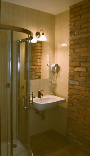 a bathroom with a sink and a shower at Hotel Gość w dom 