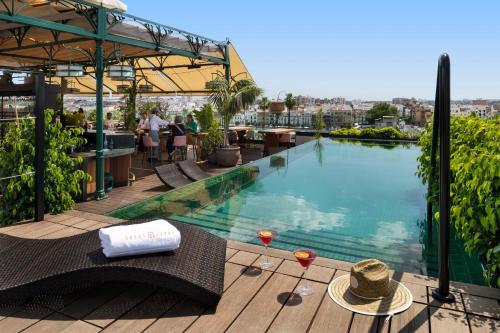 a pool on the roof of a hotel at Hotel Lobby Room Sevilla in Seville