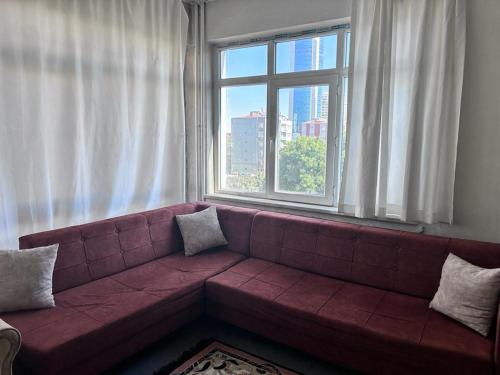 a couch in a living room with a large window at CAN REZİDANS in Konya