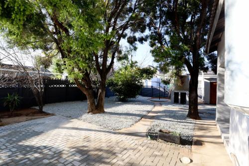 a walkway with trees and a building at Boom on Vaal in Parys