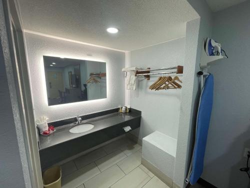 a bathroom with a sink and a mirror at SureStay Hotel by Best Western Childress in Childress