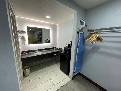 a bathroom with a sink and a mirror at SureStay Hotel by Best Western Childress in Childress