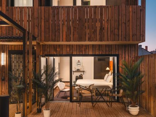 a room with a bed on a wooden deck at Marty Hotel Bordeaux - Tapestry Collection by Hilton in Bordeaux