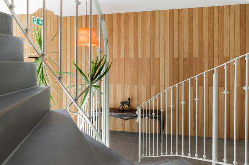 a hallway with a staircase with a potted plant at Apartamentos Plaza Center in Suances