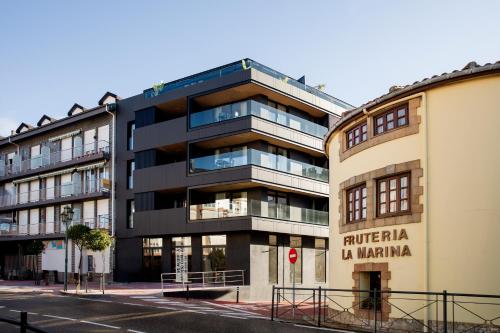 an apartment building in the middle of a street at Apartamentos Plaza Center in Suances