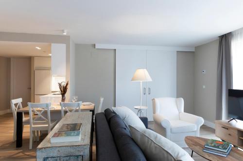 a living room with a couch and a table at Apartamentos Plaza Center in Suances