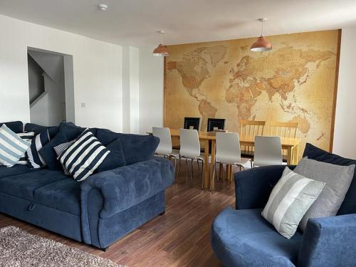 a living room with a blue couch and a table at Harcourt Place in Scarborough