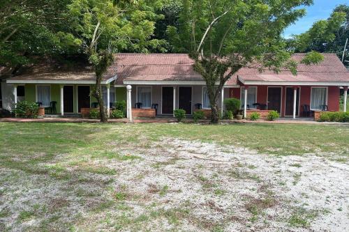 a house with a large yard in front of it at Corrie Chalet Pantai Cenang Langkawi in Pantai Cenang