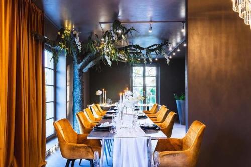 a long dining room with a long table and chairs at Royal Apartmány in Dobříš