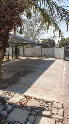 a parking lot with a canopy and a basketball hoop at Refreshing Space in Eden Glen, Johannesburg, SA in Edenvale